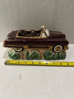 vintage ceramic car planter resembling a 1950s Cadillac convertible