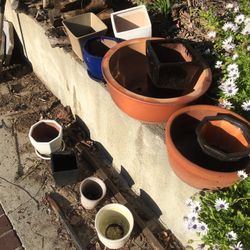 Eleven flower pots , one is  cracked