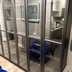 Three Matching Black Cabinets With Glass Doors