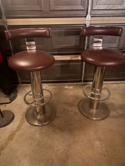 Two brown leather from bad stools