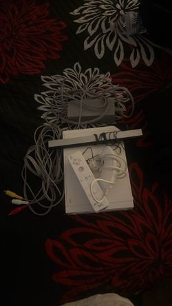 Wii console with cables, sensory bar, and controllers,