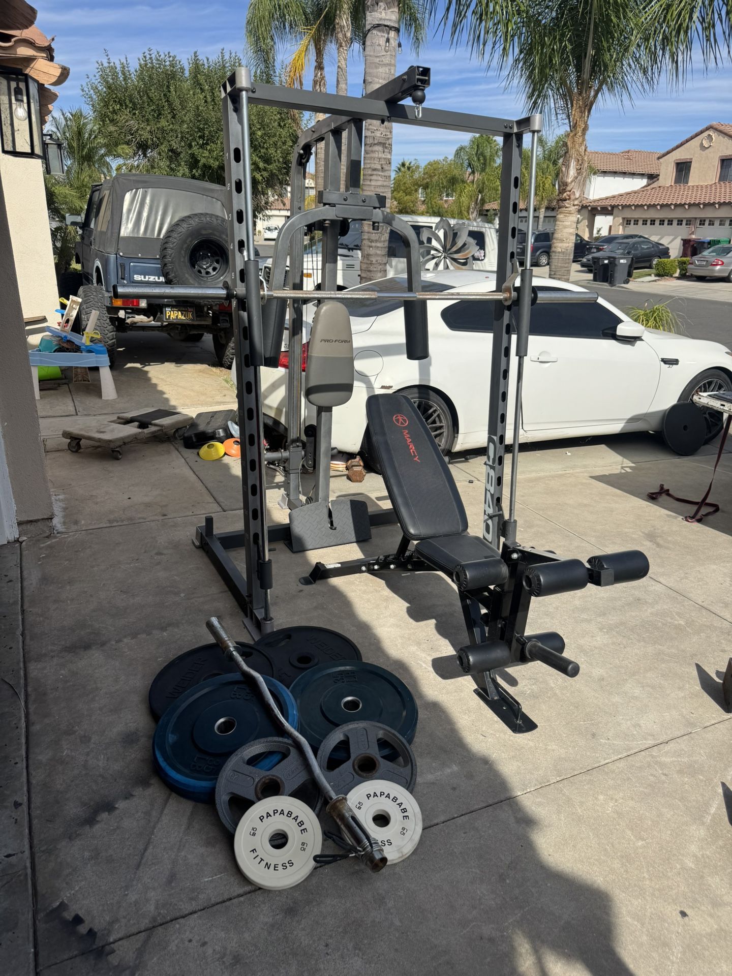 Smith machine with 230lbs of Olympic weights and curl bar