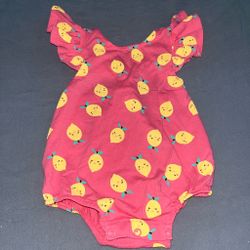 Pink baby romper with yellow lemon faces