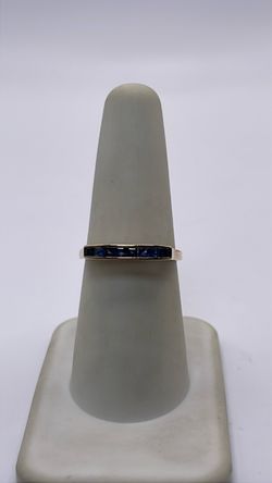 10k gold band ring with blue CZ