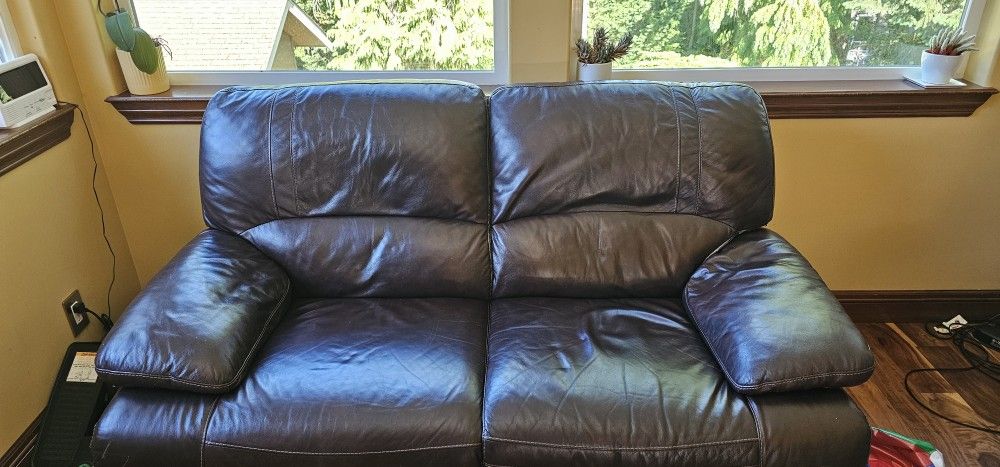 A reclinable leather sofa and love seat