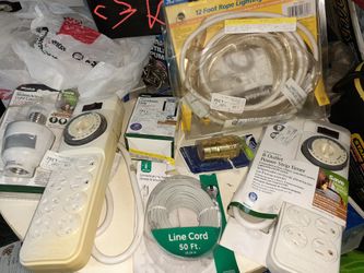 Variety of items including power outlets line cord electric timer string lights socket for light control and extension cord