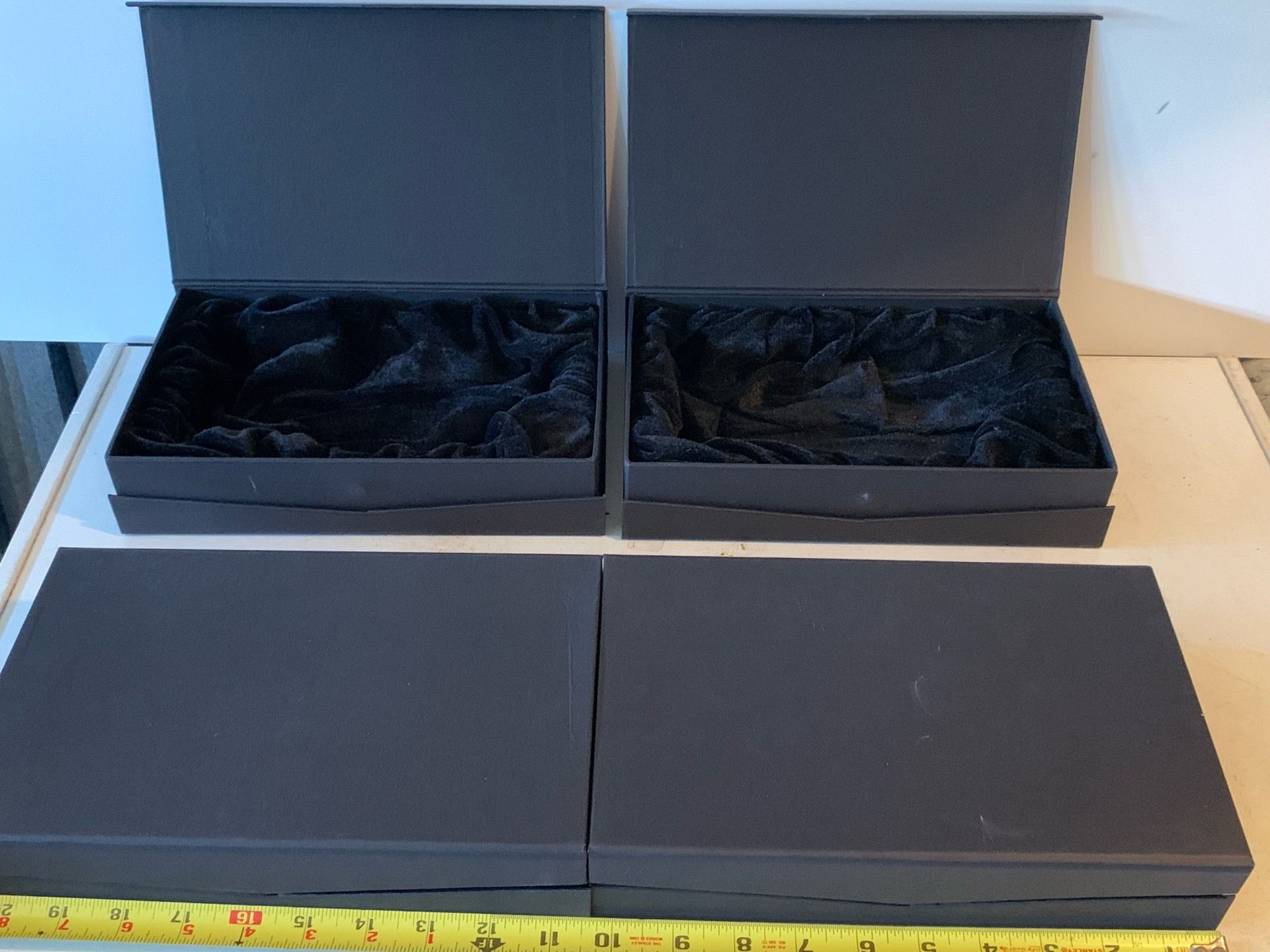 Set of 4 lined storage boxes w/ magnetic clasp, 6 by 10 by 2 inches high, lined w/ soft fabric.