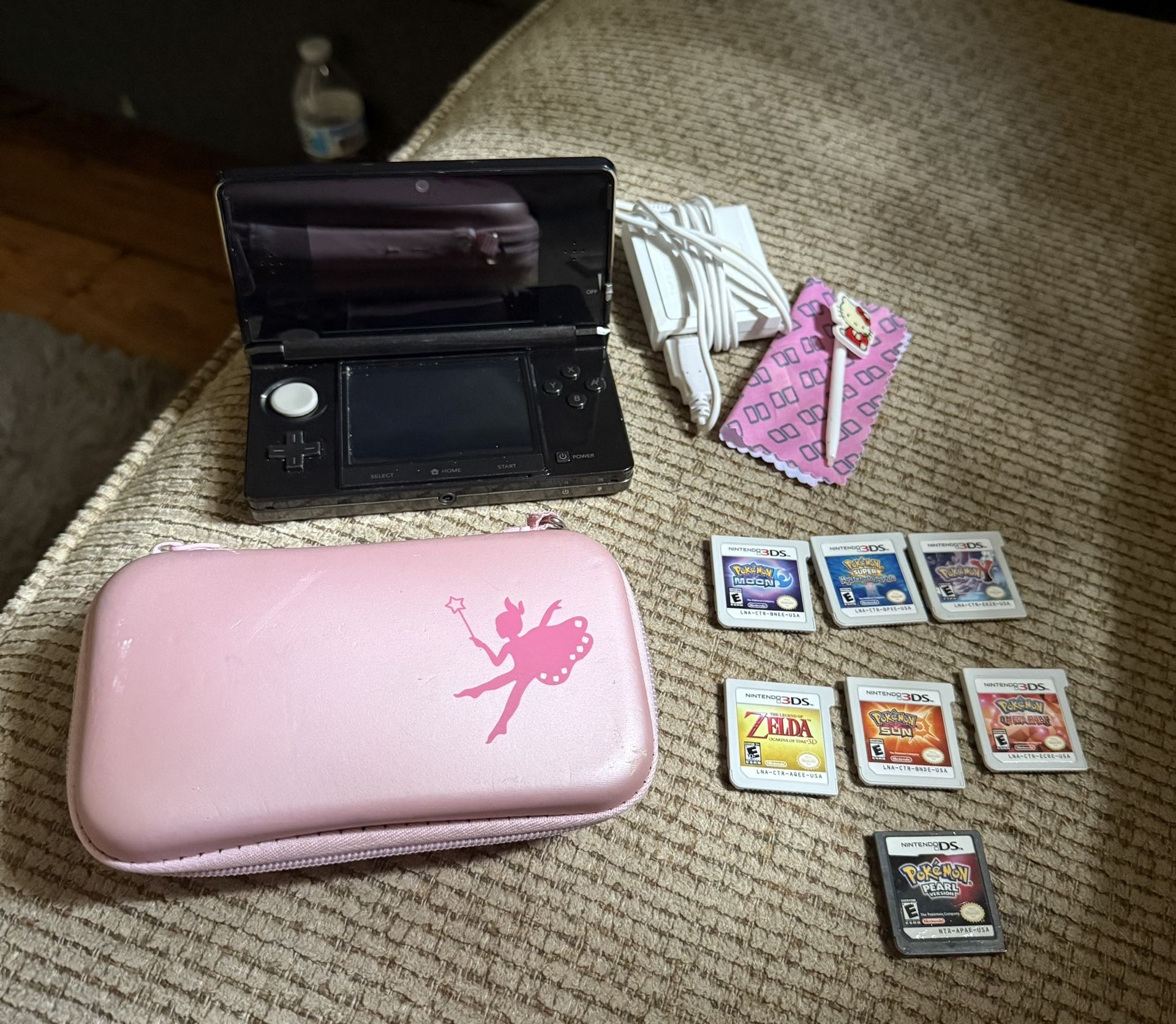 Nintendo 3Ds with seven games cartridges and a couple on the device already