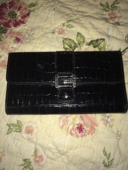 This Guess Wallet has several compartments and an outside zipper
