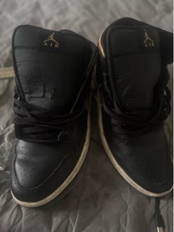 Black and gold Jordan ones