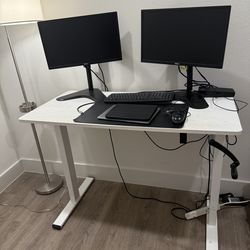 Standing desk with adjuster