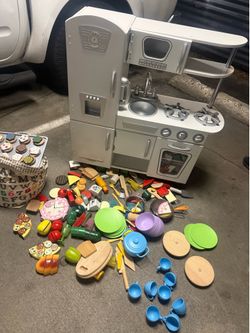 Kids play kitchen with lots of cooking ware