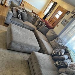 Large Gray Sectional Couch With Rug And Pillow, Ottoman Included. Free Delivery Available 