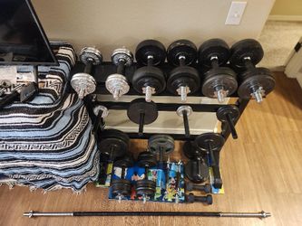 Adjustable Dumbbells, Weights, Weight Rack and bar. Over 250 lbs of weight plates.