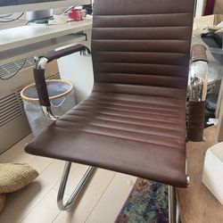 Pair of brown leather Eames style chairs with chrome frame