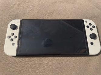 Nintendo switch oled with Mario colored joycons