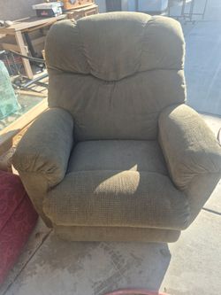 La-Z-Boy rocker recliner features a plush, segmented back design and thick, padded arms.Lazy