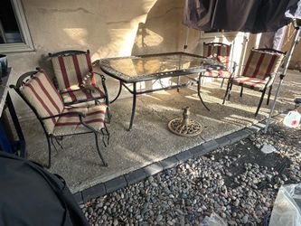 Patio table with four chairs with cushions firm on price comes with an umbrella holder