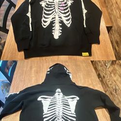Skeleton Bones Hoodie (black zip-up with white skeleton on front/back, pink tag detail)  
