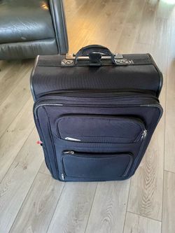 Delsey 26” checked bag with rollers.