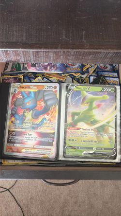 Bin of Pokémon cards with binder including Big cards