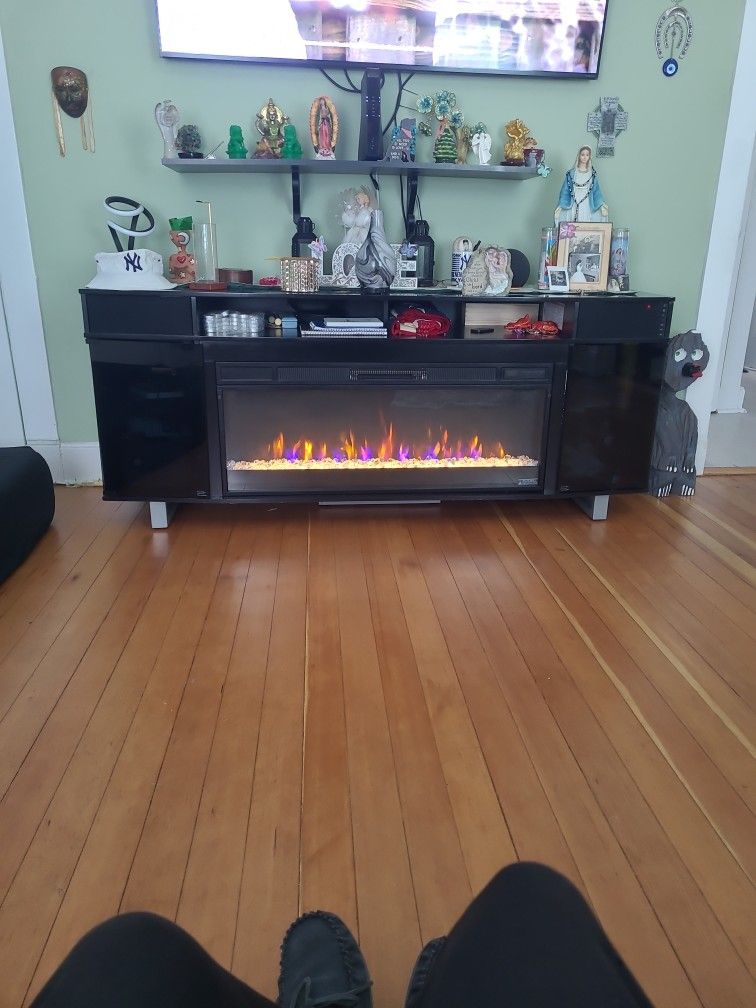 72in Electric Fireplace Good Condition 1 Burn Mark On Top From Candle Bluetooth Tooth Speakers 3 Years Old From Bob's Discount Furniture...