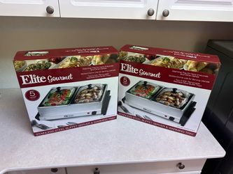 Two boxed Elite Gourmet stainless steel electric buffet servers and warming trays.