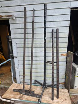 metal pipes and racks, parts of complex equipment, tripods, lighting/background stands or structures for dismantling/construction purposes.