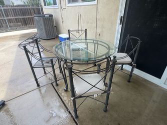 Heavy duty cast iron patio set with four chairs and a table