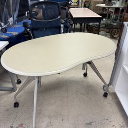 HOWARD MILLER kidney-shaped tabletop supported by three adjustable legs with casters - 47” x 30” - Excellent Condition- Originally $1899