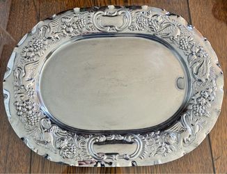 Metal serving platter with raised decorative design. 12 1/2”X16”.
