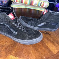 Black and black high top vans
