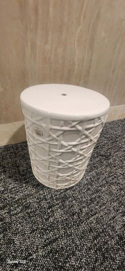 Emissary white ceramic garden stool featuring a cane-inspired woven design and a glossy glaze.