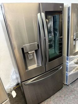 Counter depth LG stainless steel French door refrigerator and bottom freezer and instaview window