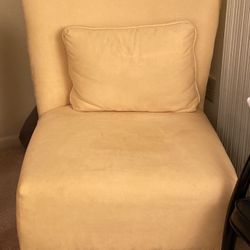Yellow armless chair.
