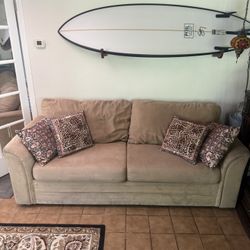 Tan Couch With Leopard Pillows 
