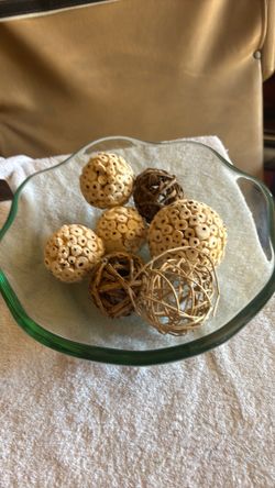 Decorative bull features a ruffled edge design filled with natural fiber, orbs and rattan wicker balls