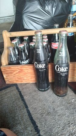 Old coke bottles, Pepsi & (1) 7up 24 bottles in all.still full of soda