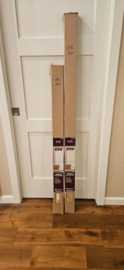 Two beige cordless window blinds