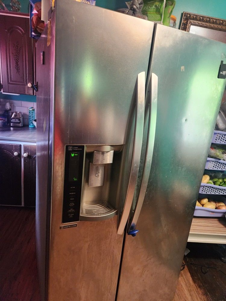 Lg Refrigerator And Samsung Stove Range. 
