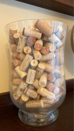 Glass urn full of wine corks