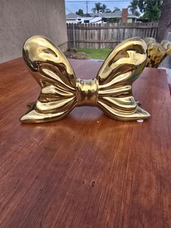 glossy gold-finished bow home decor piece