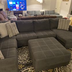 Beautiful gray three-piece with ottoman