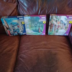 Three  boxes of puzzles , Buy The Boxes For $ 14 Or 5dl  Each