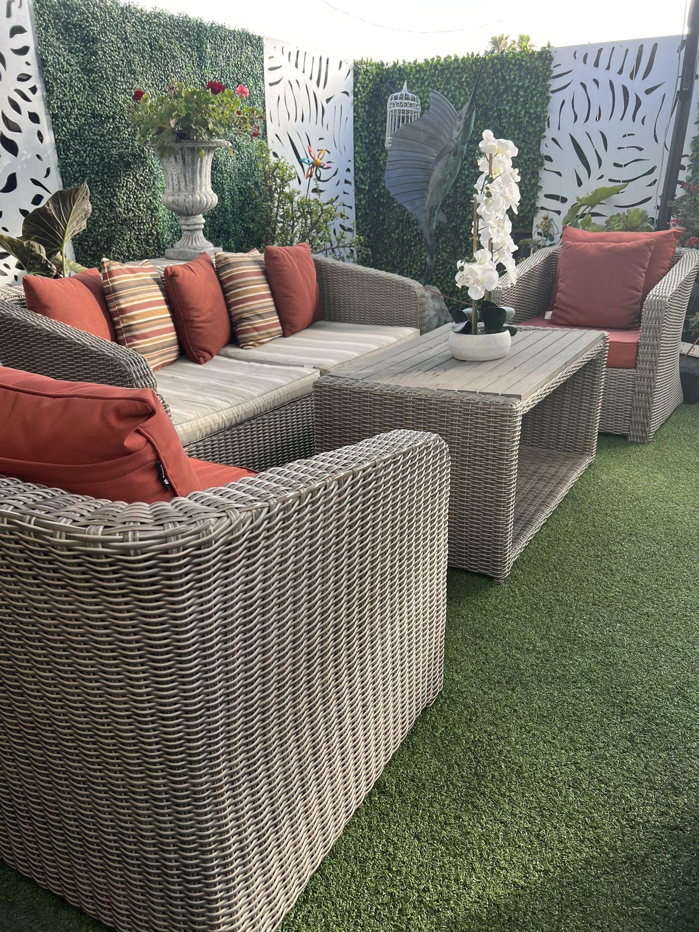 Beautiful 4-piece wicker patio set in good condition. Both sofa seat cushions need replacing.