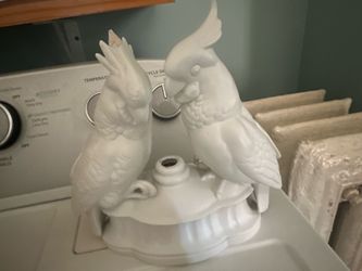 Elegant white porcelain bird figurine. Has chip on one head.