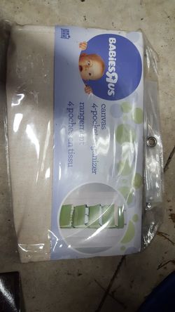 Brand new- 4 pocket organizer that hangs behind a door light tan in color
