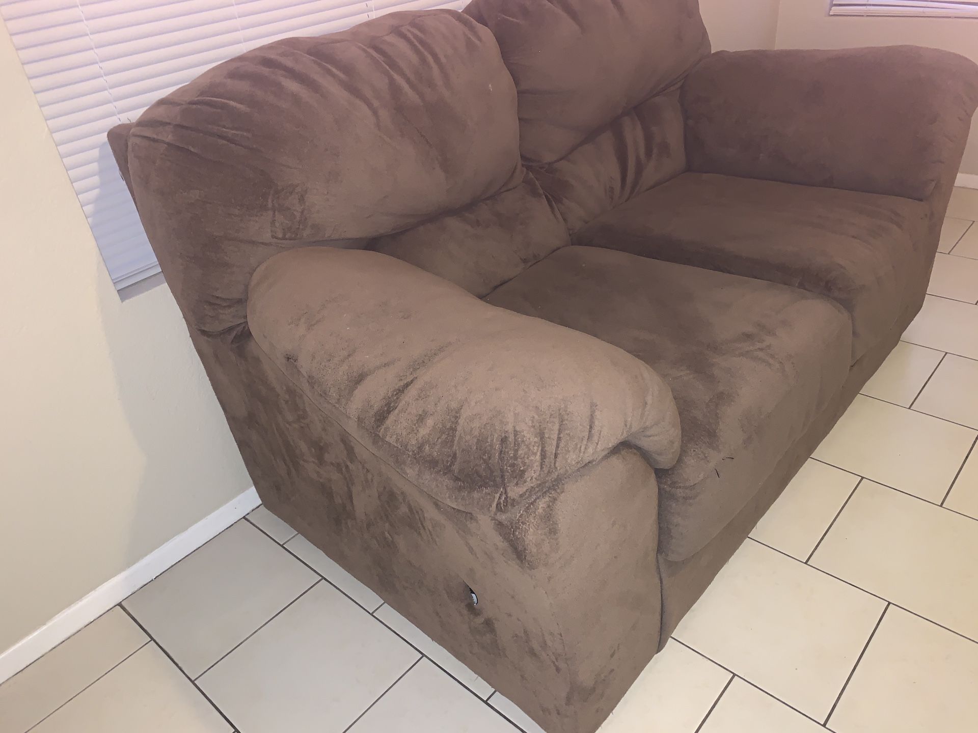 Clean Love seat furniture with small Tear on side couch very comfortable
