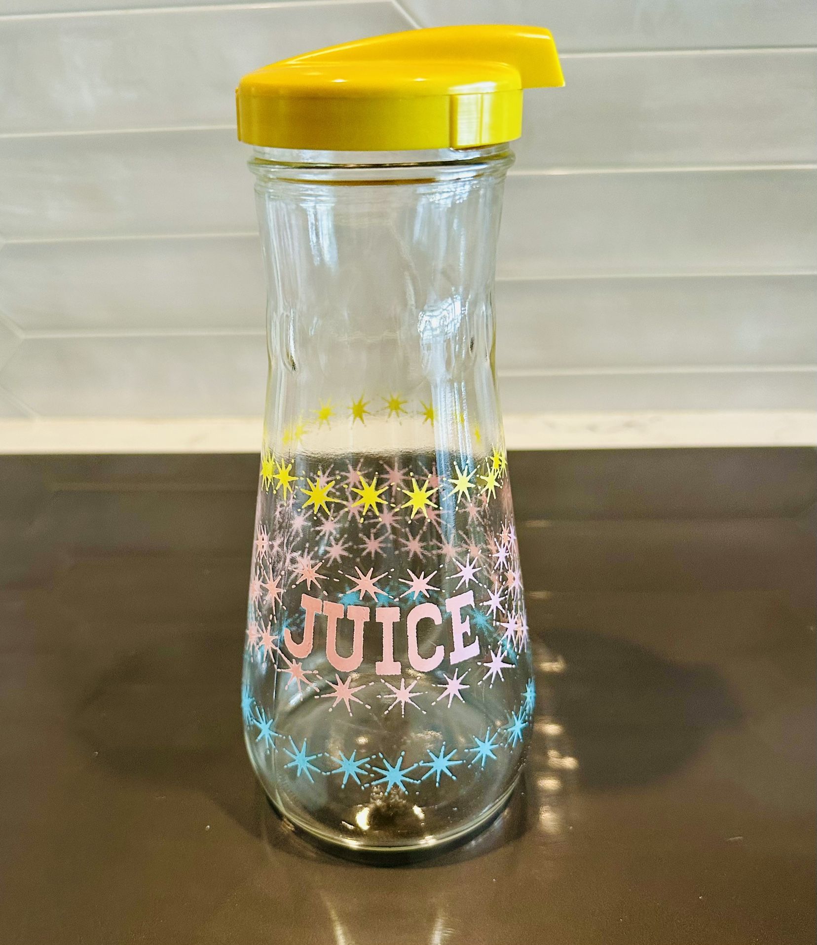 Vintage Hazel Atlas Atomic Starburst Juice Carafe with lid. Pink, yellow and turquoise starburst pattern is bright and shiny.