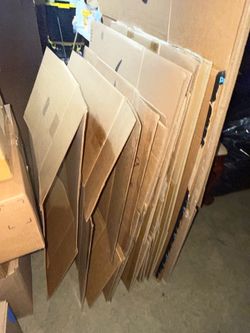 Large collection of flattened cardboard boxes in various sizes, including a large Amazon box. Used but structurally intact. Good for moving, shipping,